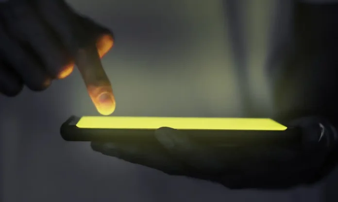 mao-tocando-a-tela-iluminada-do-smartphone